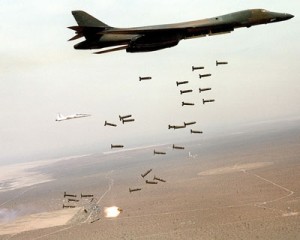 A B1 bomber dropping hundred of undirected 'dumb' bombs that indiscriminately destroy. maim and kill civilians. 
