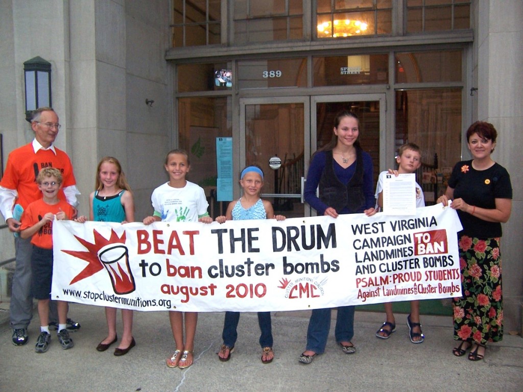 Students hold "Beat the Drum" banner in front of Morgantown City Hall