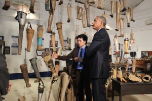 During President Obama's historic visit to Laos, he met with cluster bomb victims and toured the Cooperative Orthotic and Prosthetic Enterprise (COPE) visitors' centre in Vientiane with its operations manager Soksai Sengvongkham, September 2016.  © 2016 Khamchanh Phetsouphan 